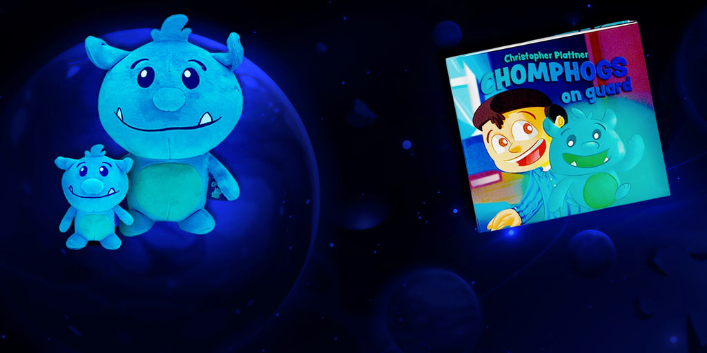 a group of blue Chomphog plush toys against a space background, with a story book for children scared of the dark